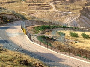 road with electrified fence and razor wire
